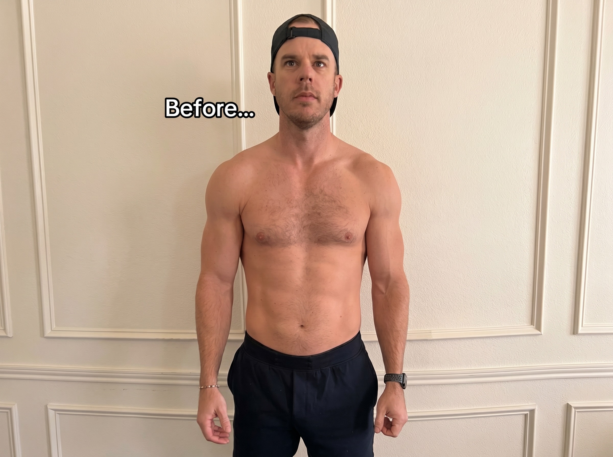Before photo: shirtless man in a backwards cap standing in front of a wall, baseline physique.